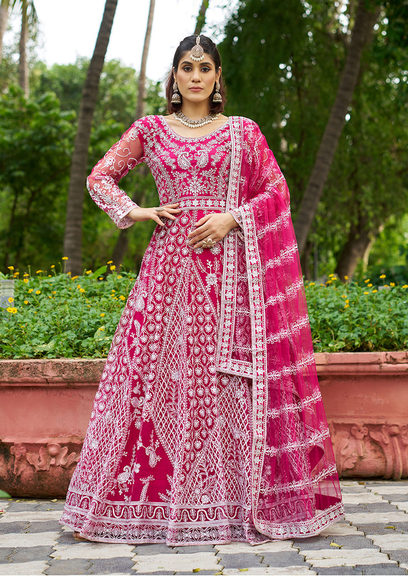 Vibrant rani pink net Anarkali gown featuring detailed embroidery