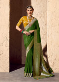 Green crepe and georgette saree featuring detailed gold zari weaving work