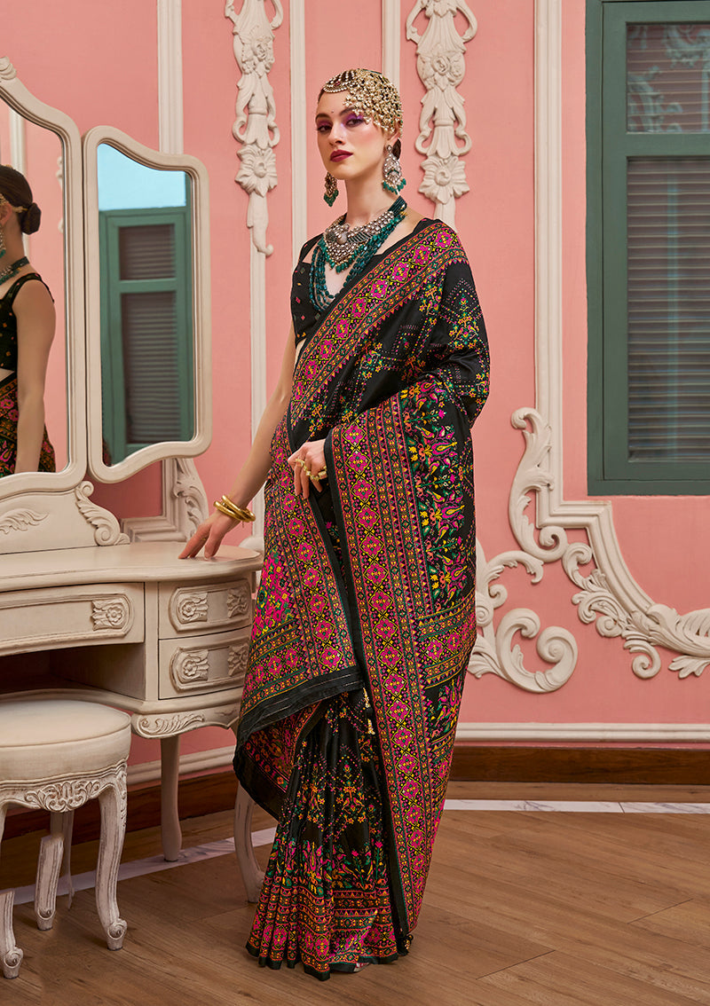 Model wearing a black Banarasi silk traditional saree with intricate meenakari and weaving work