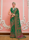 Green Banarasi silk saree with traditional Meenakari weaving details
