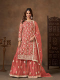 Elegant coral net salwar kameez with detailed embroidery and sequins for festive wear