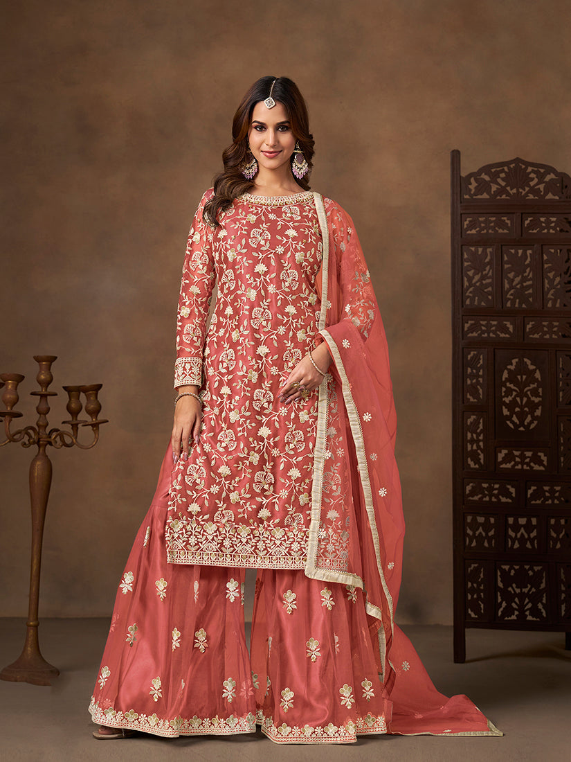 Elegant coral net salwar kameez with detailed embroidery and sequins for festive wear