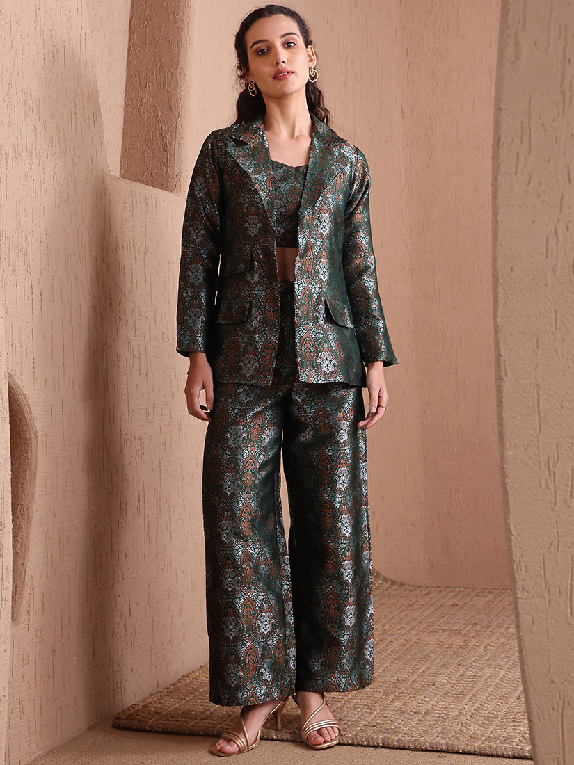 Model wearing a green Banarasi brocade 3-piece co-ord set with a designer blazer and wide-leg trousers.