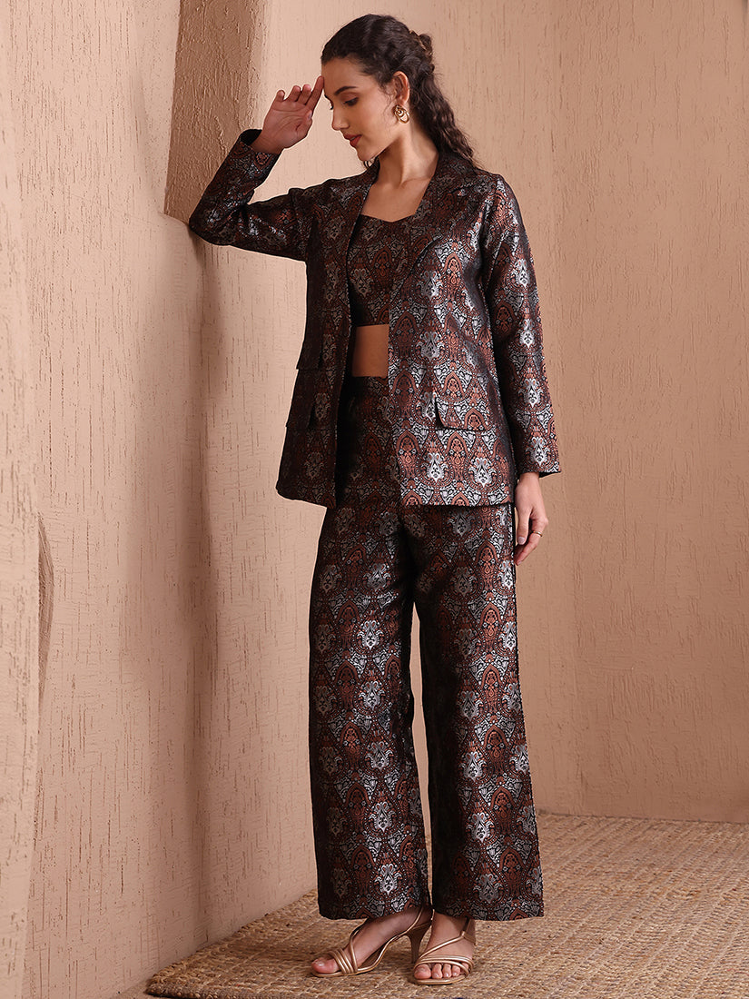 Woman wearing a black Banarasi brocade 3-piece co-ord set with a designer blazer and wide-leg trousers.
