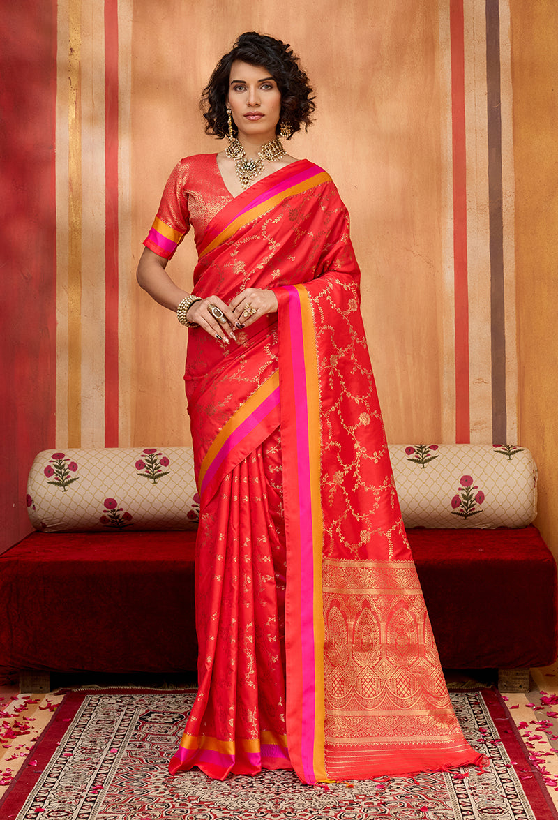 Woman wearing a vibrant red satin silk blend woven saree with ethnic patterns