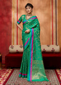Sea green satin silk blend saree with detailed ethnic weaving work