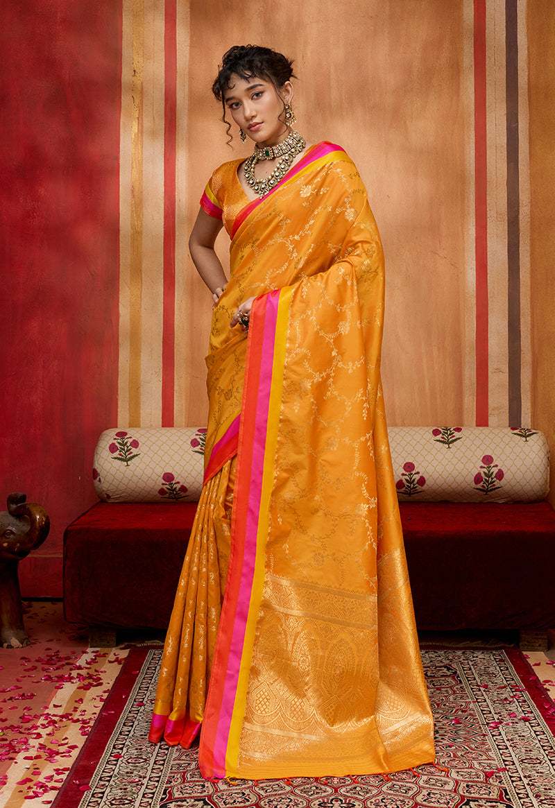 Orange satin silk blend saree with intricate ethnic weaving and matching blouse for festive occasions