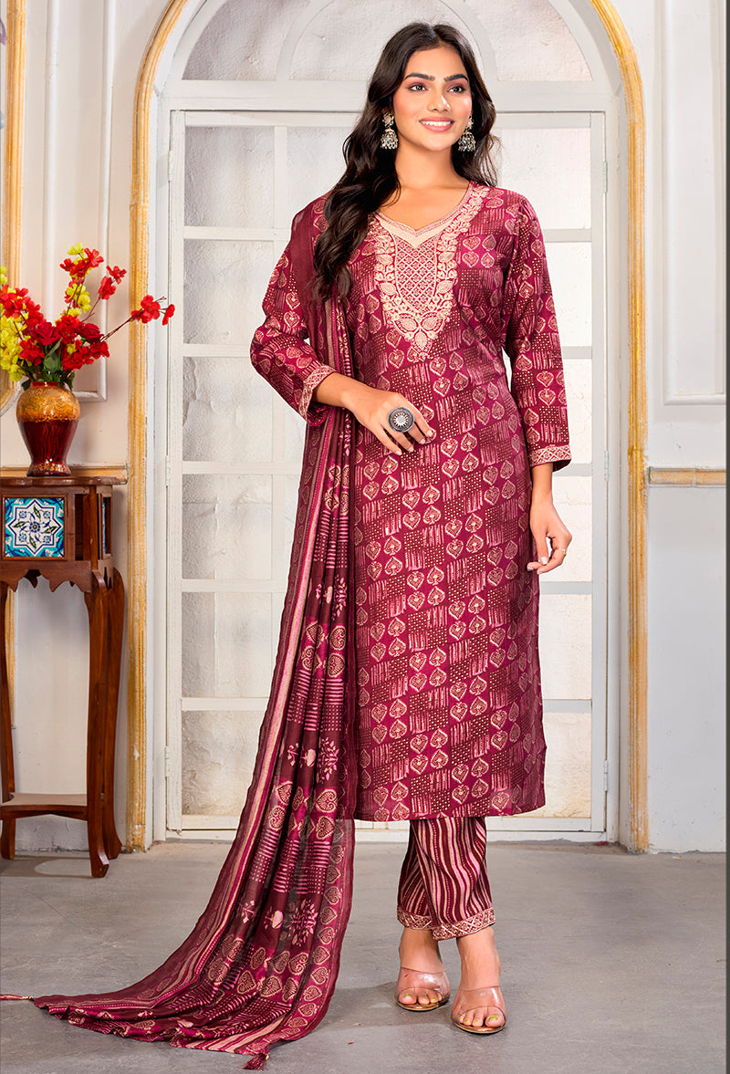 Woman wearing a crimson Chanderi silk embroidered pant style suit with matching dupatta