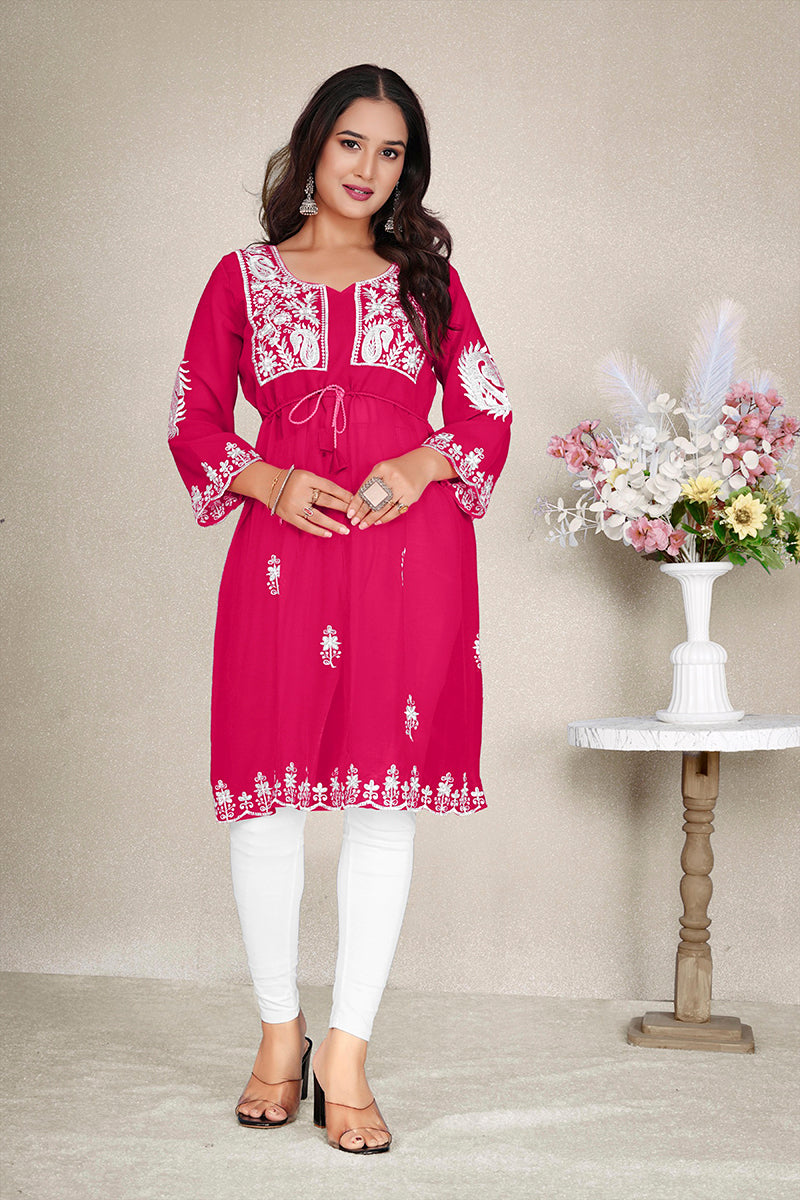 Woman wearing a Rani Pink embroidered georgette casual kurti with elegant detailing