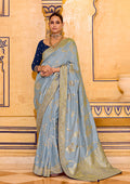 Close up of light blue faux crepe silk saree with detailed gold zari weaving