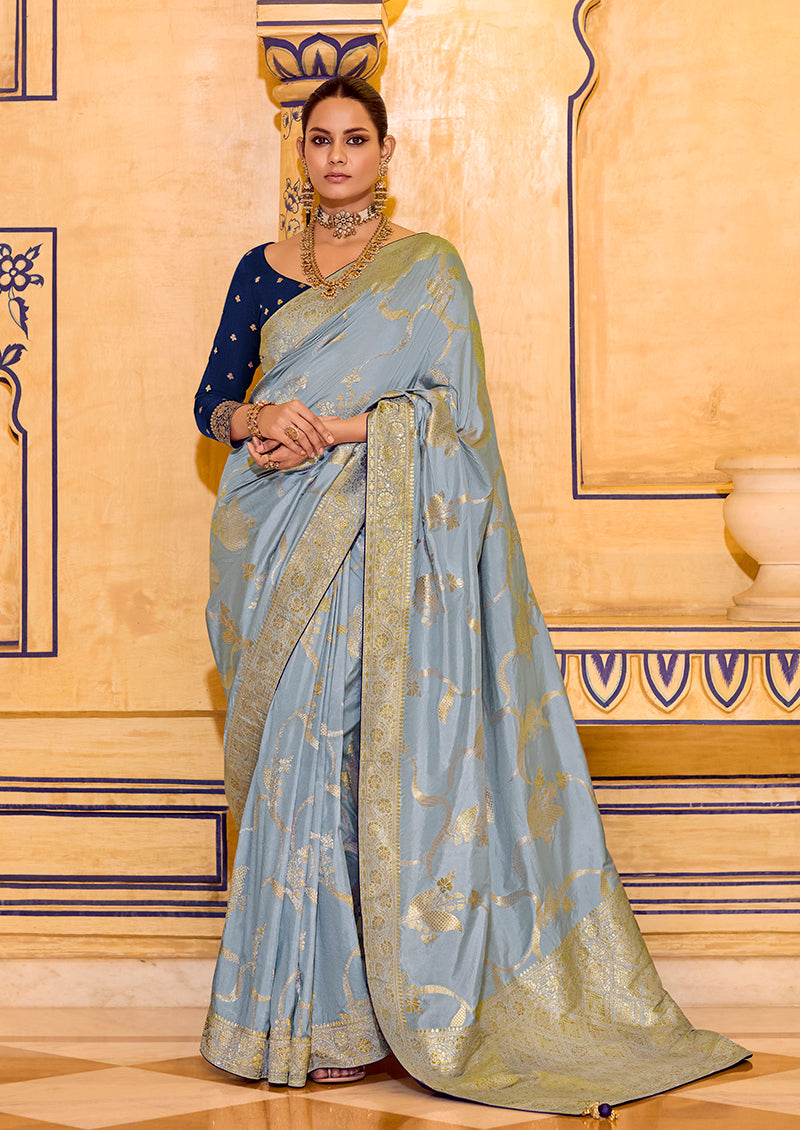 Close up of light blue faux crepe silk saree with detailed gold zari weaving