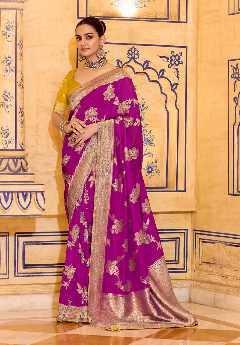 Magenta faux crepe silk saree with intricate gold Zari weaving work draped elegantly.