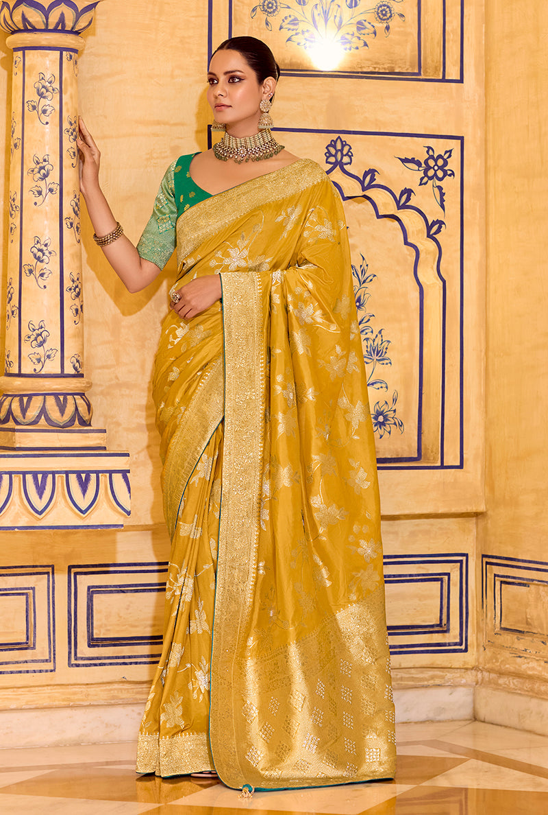 Mustard faux crepe silk saree with intricate gold Zari weaving work draped elegantly
