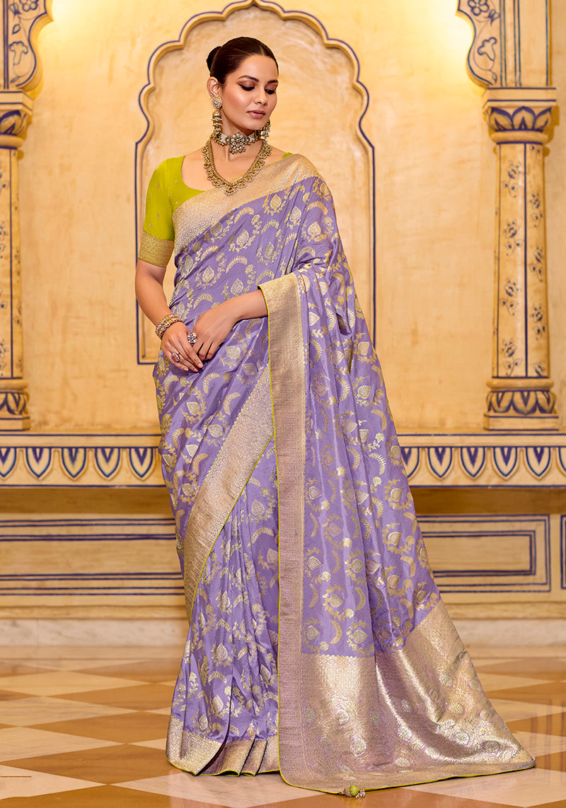 Lavender faux crepe silk saree with elegant Zari weaving work and a soft, flowing drape.