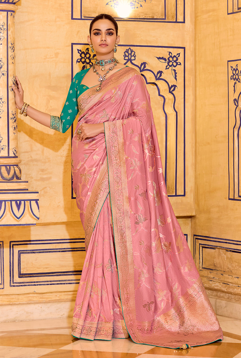A baby pink faux crepe silk saree for children featuring intricate gold zari weaving patterns.