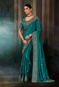 Teal faux satin saree with heavy embroidered border and matching blouse for wedding reception