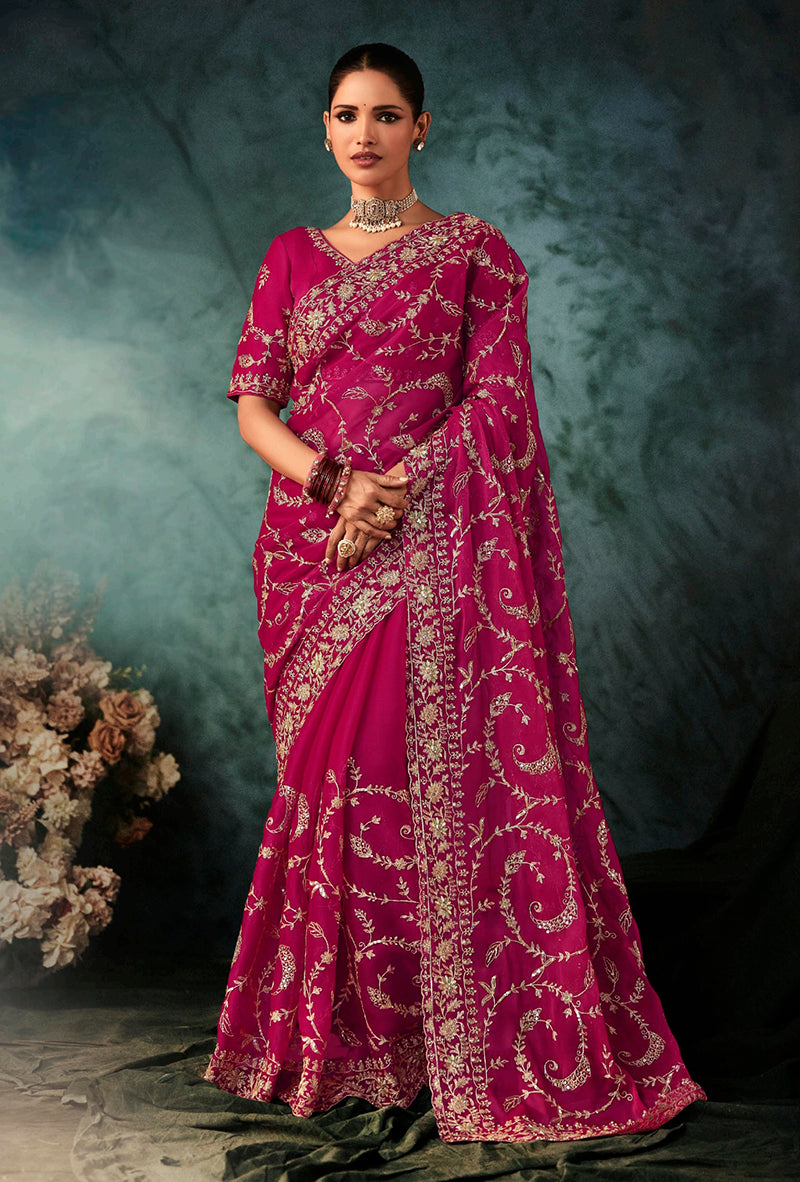 Rani Pink faux crepe wedding saree with heavy embroidered border, styled for bridal reception.