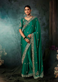 Teal green faux satin wedding saree with heavy embroidery and decorative border