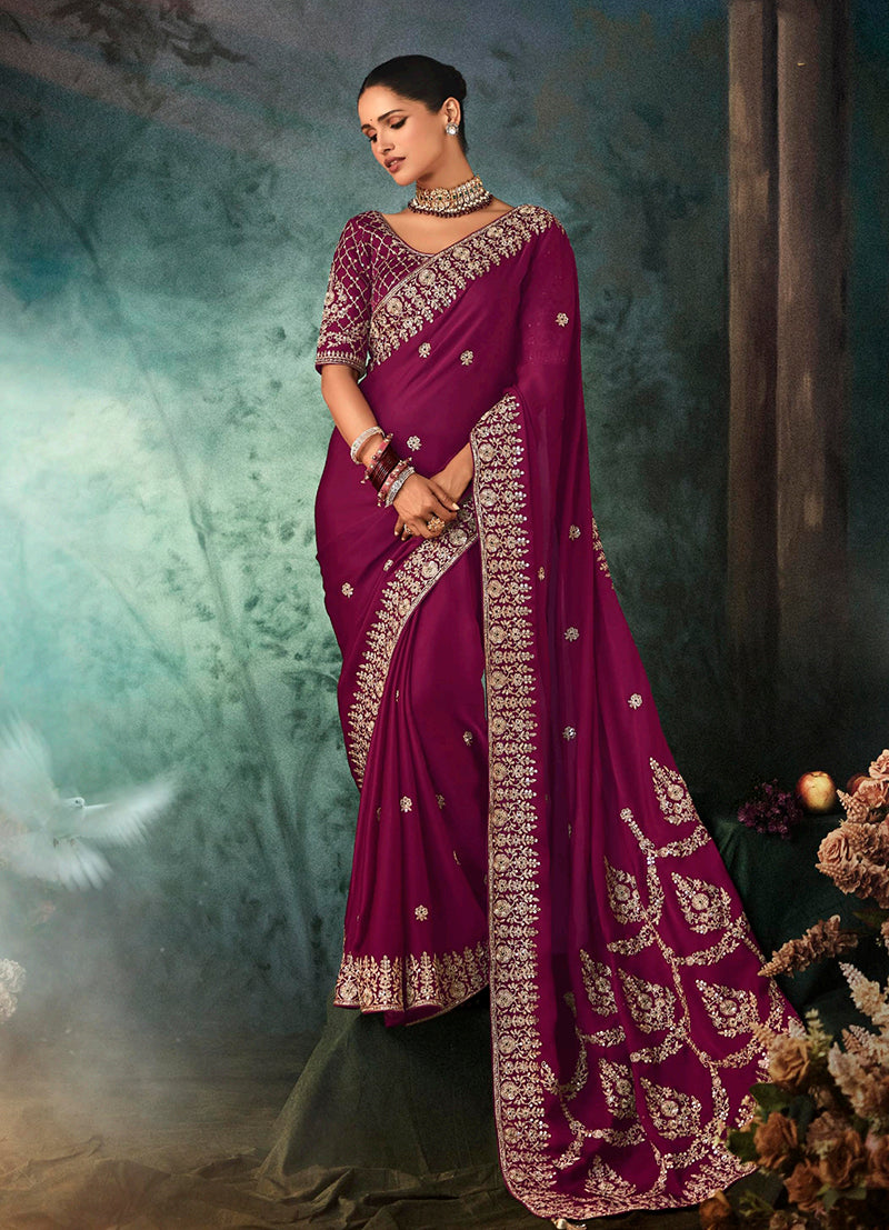 Elegant burgundy faux satin saree with heavy decorative border and intricate embroidery for wedding wear.