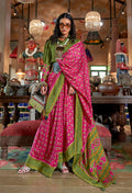Rani pink and green ikat print silk blend saree with contrast border