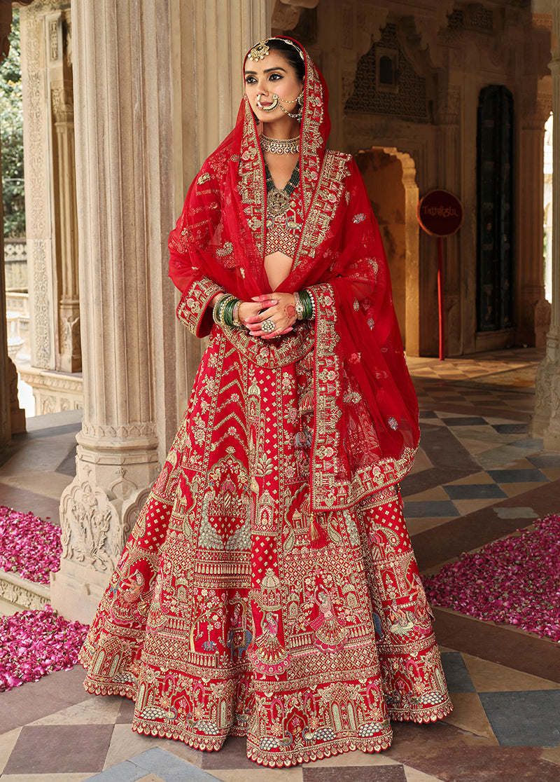 Model wearing a vibrant red silk blend bridal lehenga choli with intricate Khatli embroidery.