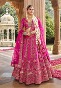 Close up of magenta pink silk blend bridal lehenga with detailed Khatli embroidery.