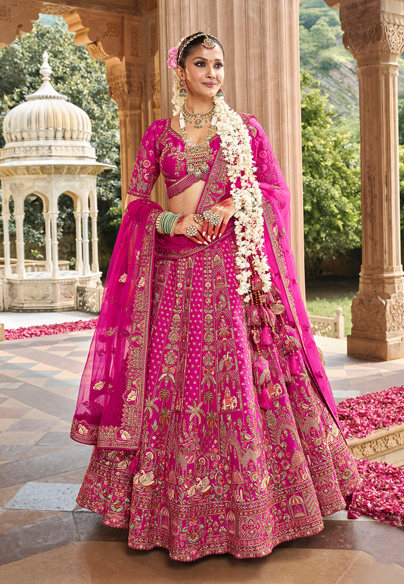 Close up of magenta pink silk blend bridal lehenga with detailed Khatli embroidery.