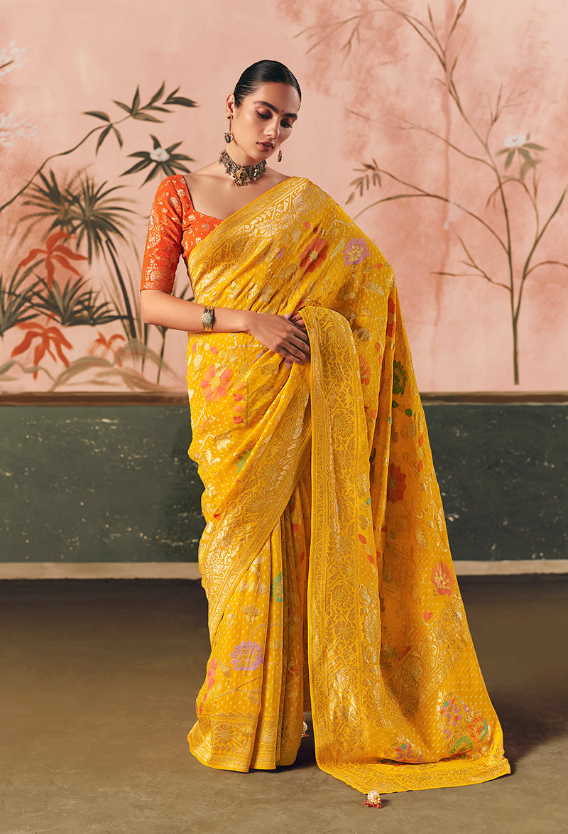 Traditional yellow Bandhej saree in faux khadi georgette with intricate weaving patterns