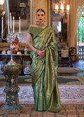 Woman wearing a traditional green Kanjivaram silk blend saree with intricate gold woven detailing