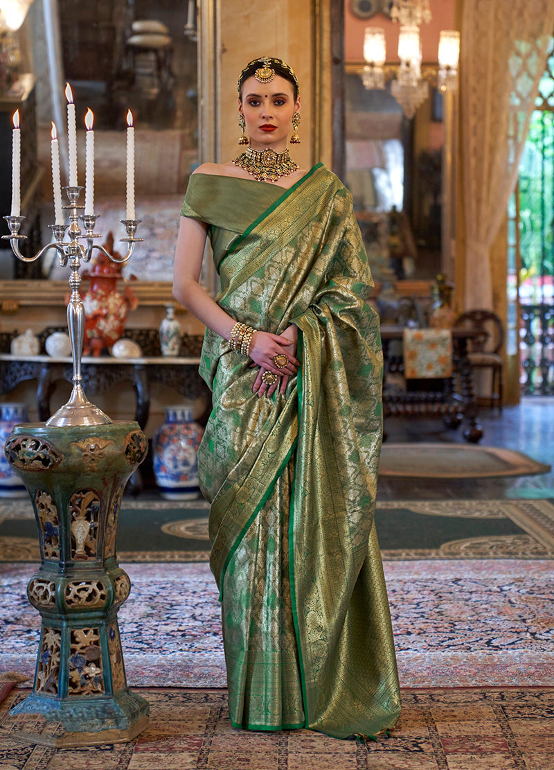 Woman wearing a traditional green Kanjivaram silk blend saree with intricate gold woven detailing