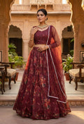 Wine colored floral organza lehenga choli with designer blouse.