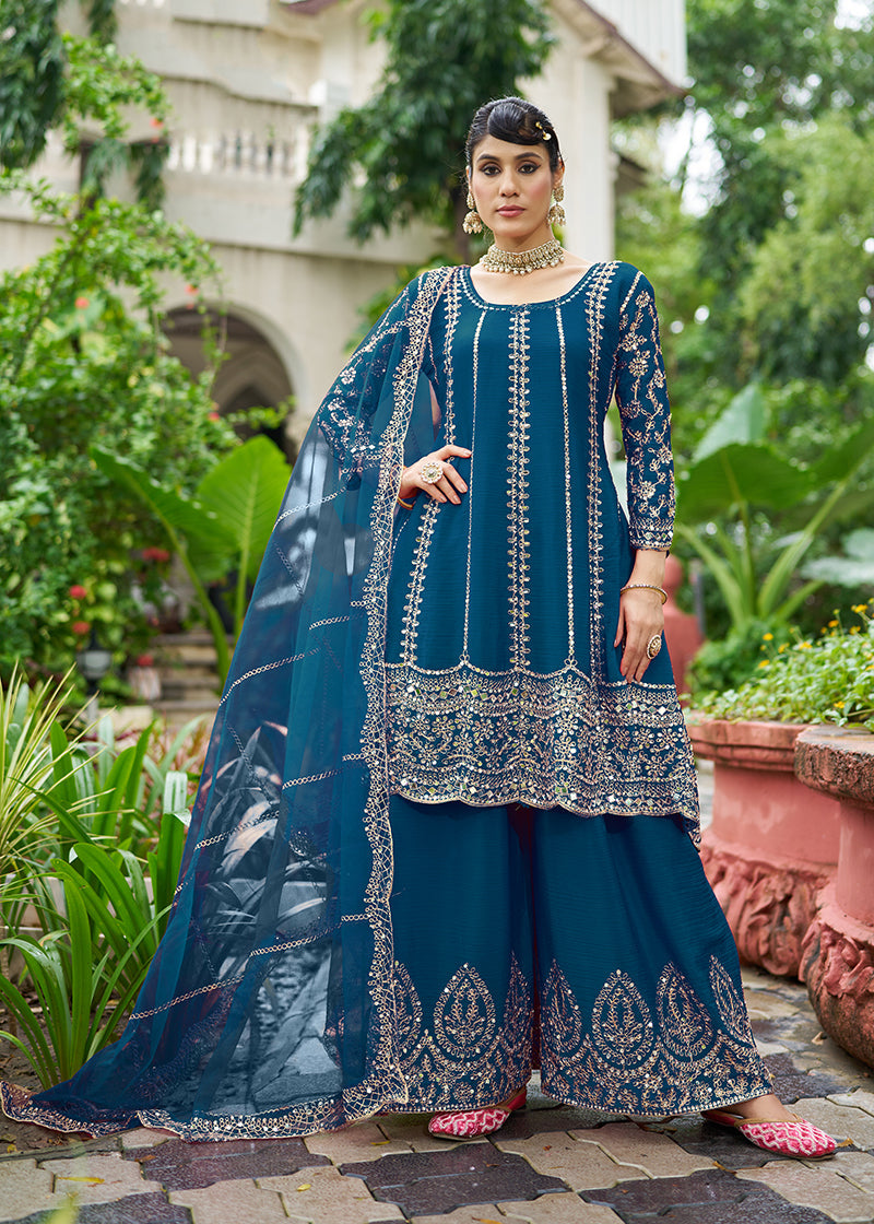Woman wearing a peacock blue embroidered chinnon palazzo kameez with mirror work detail