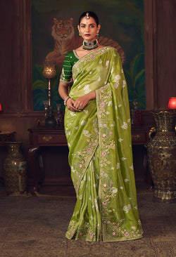 Parrot green silk blend saree with intricate zari weaving and matching stone-embroidered blouse