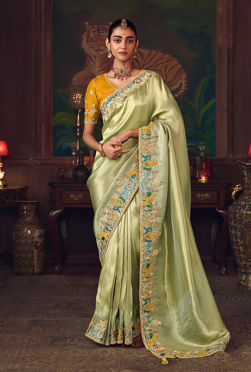 Light green silk blend wedding saree with zari weaving and contrasting mustard embroidered blouse