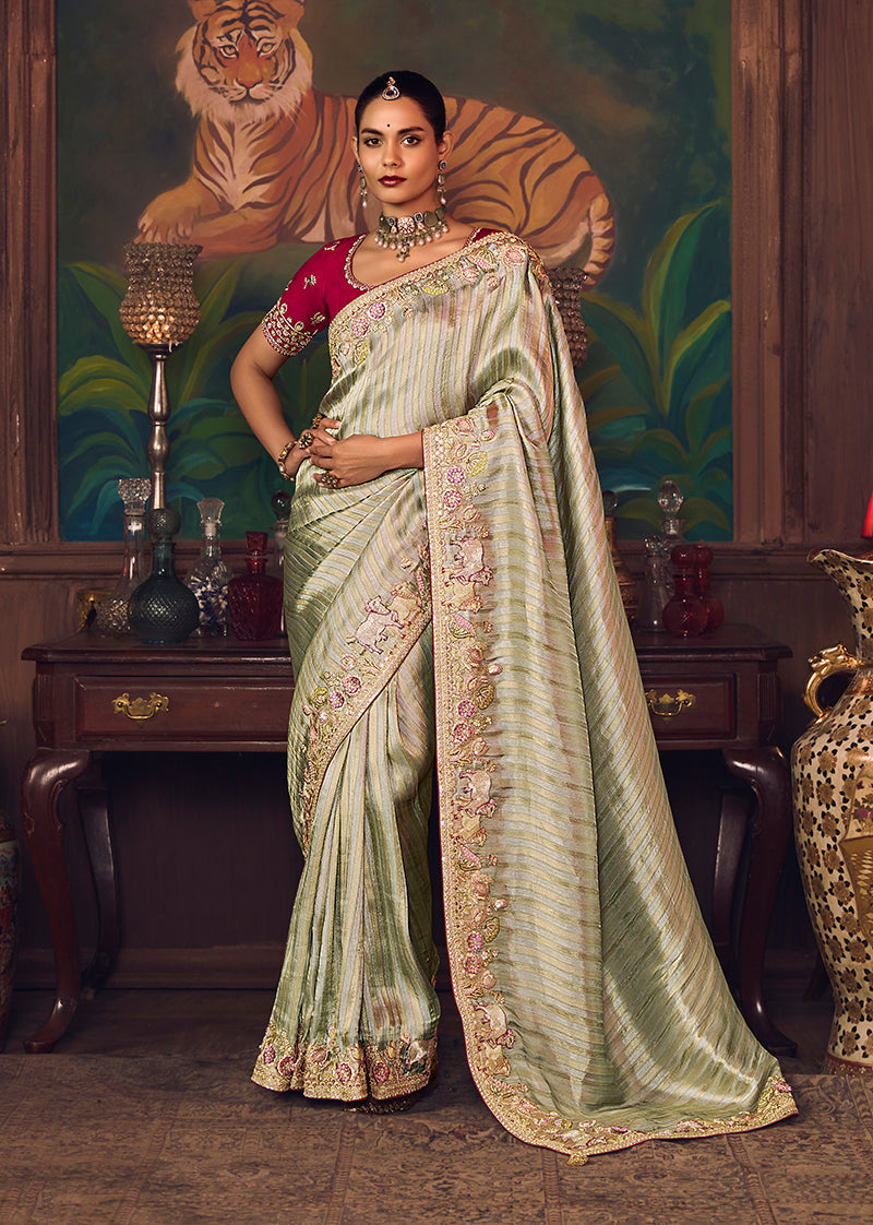 Sea Green silk blend saree with traditional zari weaving, sequins, and stone embroidery featuring a rani pink blouse