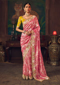 Coral pink silk blend saree with zari weaving and stone embellishment paired with a yellow blouse