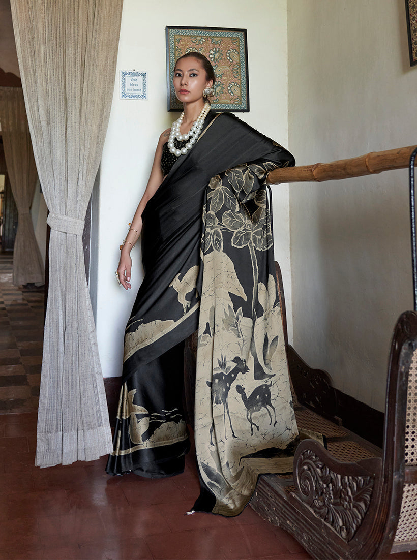 A graceful black satin saree with ethnic prints and a matching blouse, perfect for casual ethnic styling.
