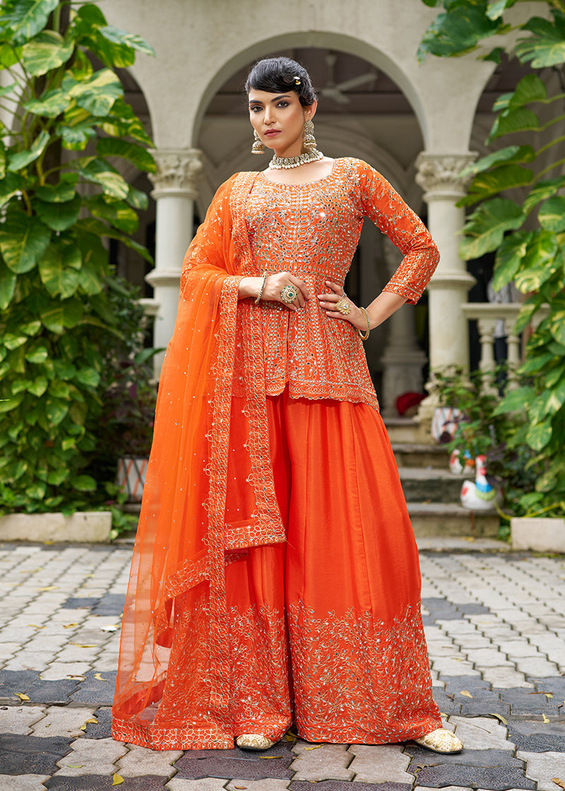 Orange chinon palazzo kameez featuring intricate embroidery for a festive look.