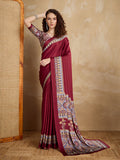 A maroon satin saree featuring vibrant multi-colored printed border and pallu, elegantly draped.