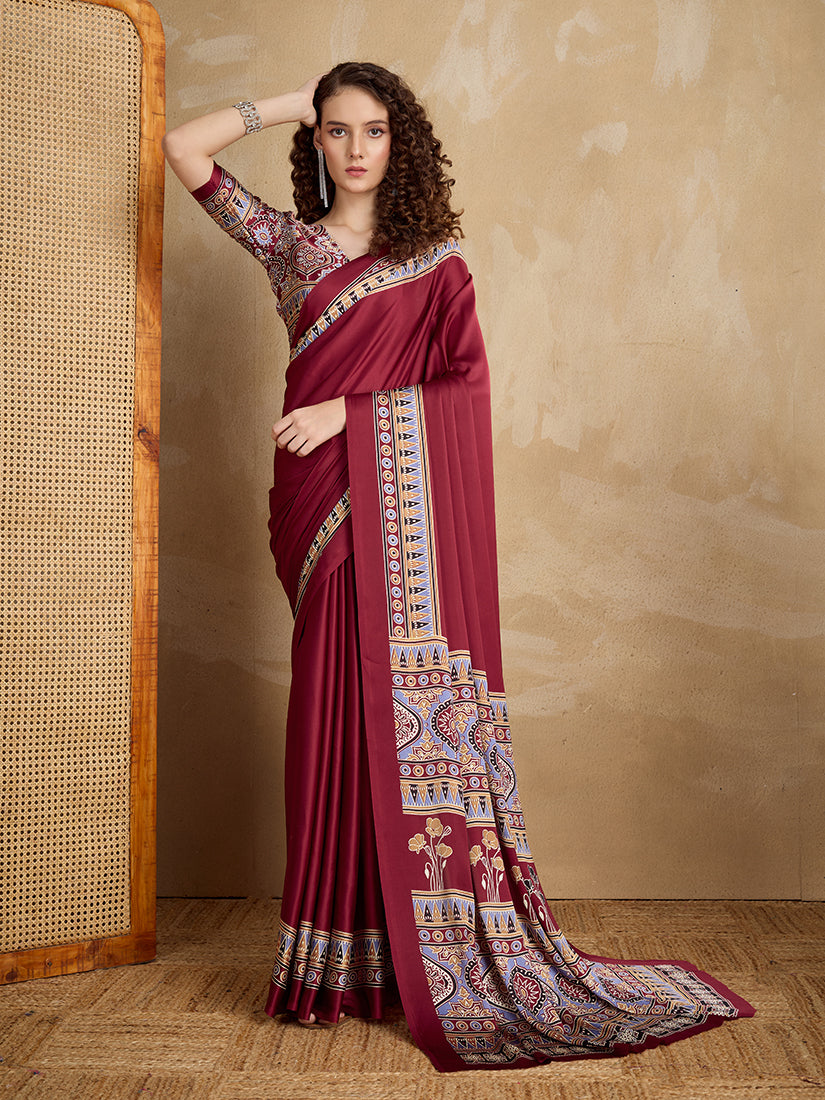 A maroon satin saree featuring vibrant multi-colored printed border and pallu, elegantly draped.