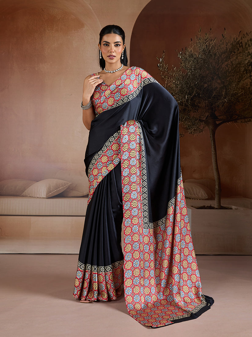 Monjolika Fashion black printed satin saree with elegant pallu and matching blouse fabric