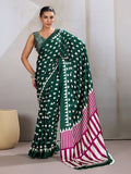 Dark green satin saree adorned with traditional Ajrakh prints