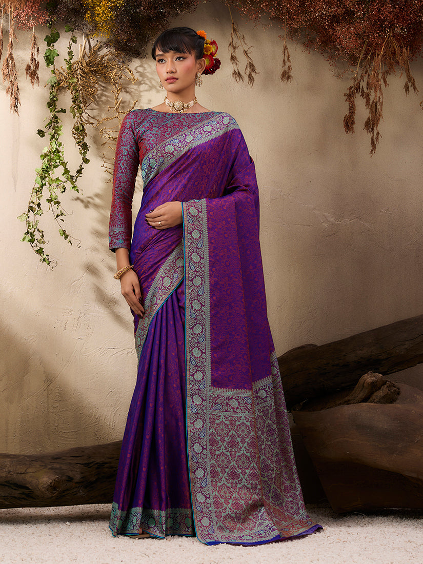 A graceful purple Kanjivaram silk blend saree with traditional woven border and patterns.