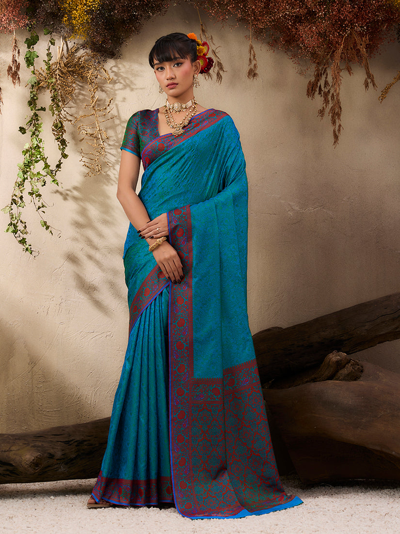Teal blue Kanjivaram silk blend saree with traditional woven patterns.