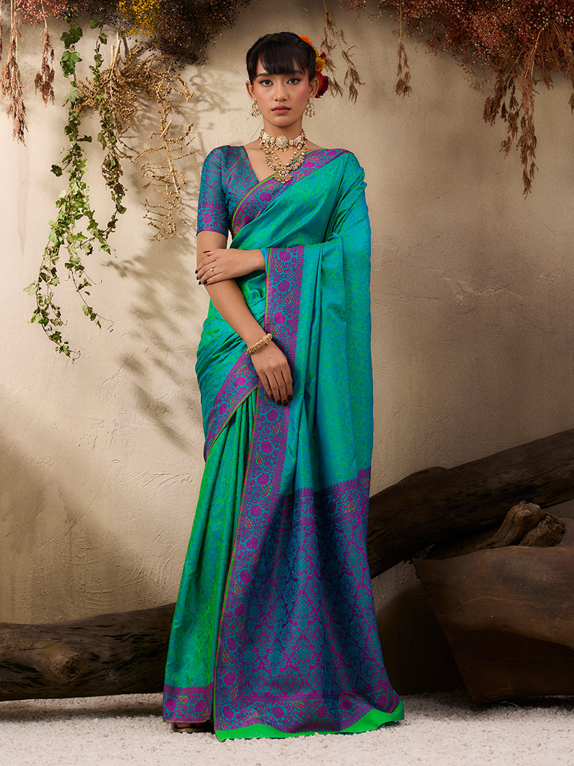 Turquoise Kanjivaram silk blend saree with intricate golden woven border.