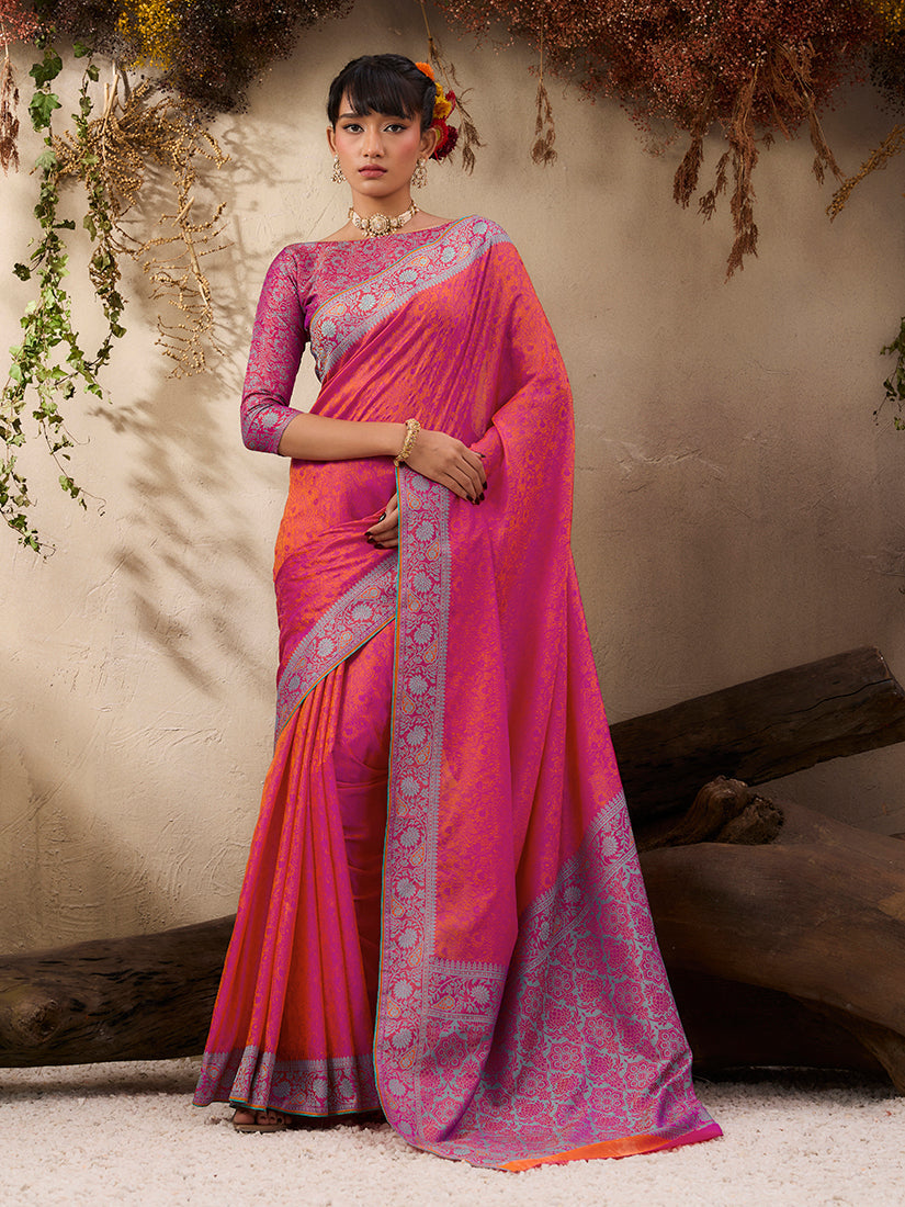 A beautiful salmon-colored woven Kanjivaram silk blend saree with intricate gold weaving details.