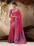 A beautiful salmon-colored woven Kanjivaram silk blend saree with intricate gold weaving details.