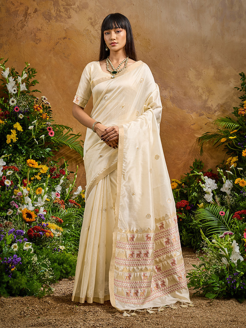 Woman wearing an elegant off white Tussar silk blend saree with intricate woven patterns