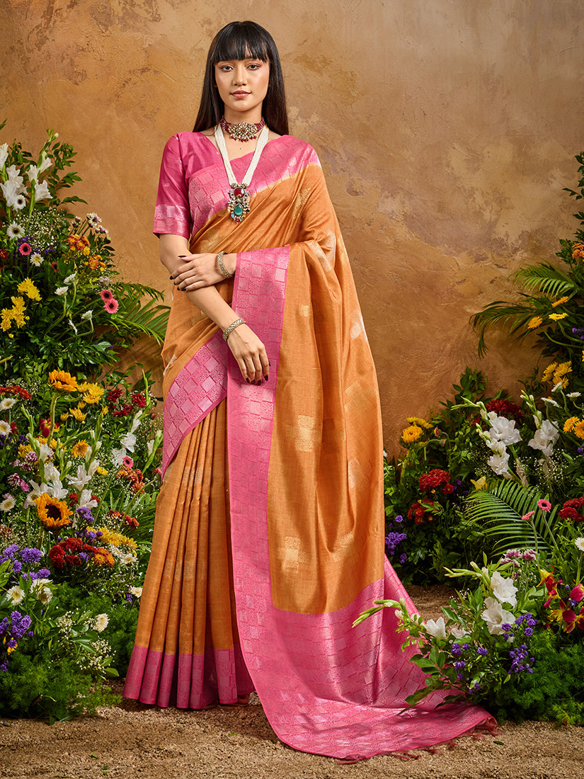 Model wearing a rust-colored silk blend saree with intricate woven work and unstitched blouse