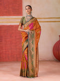 Orange silk blend traditional saree featuring ornate woven work and a luxurious sheen